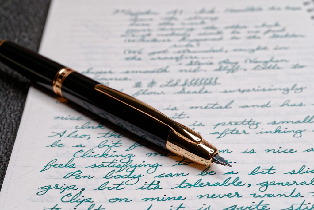 A photo of the close-up details of a Majohn A1 from the nib side. It shows the nib, clip, and nose cone in sharp detail.