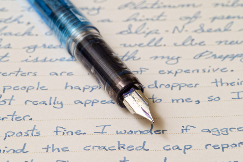 A photo of the Platinum Preppy grip section and 03 Fine nib over writing on a piece of notebook paper.
